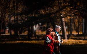 man and woman walking in a park