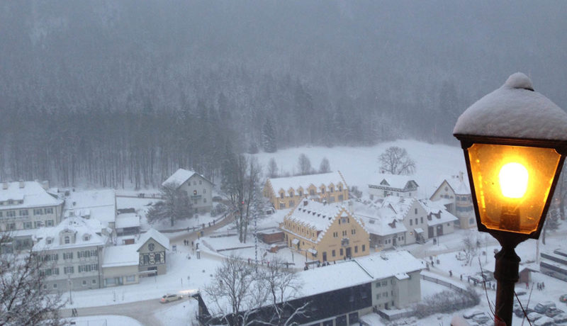 small town in winter with lamplight in foreground